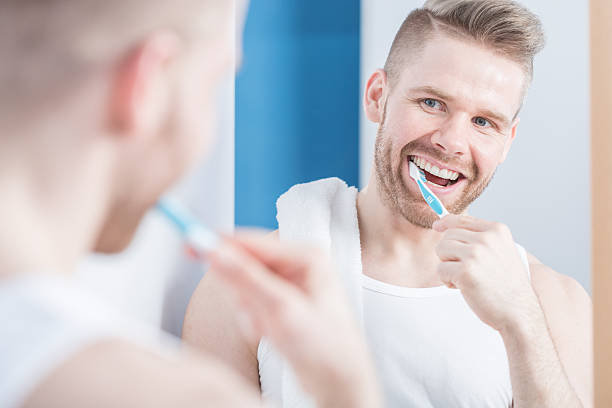 istock Young fashionable man brushing teeth 501798944
