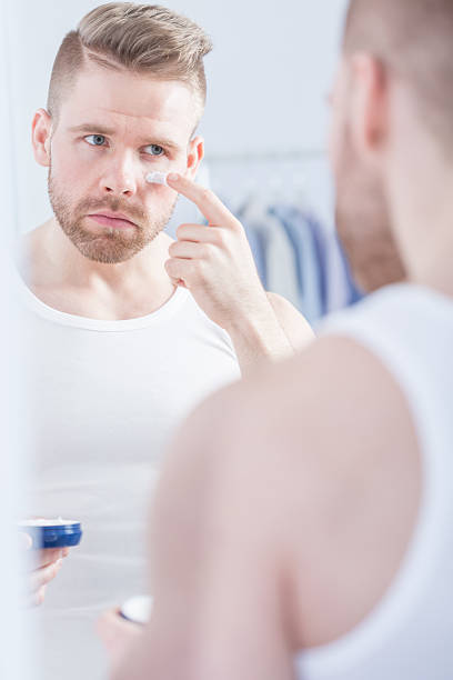 istock Well kempt man applying cream 501799000