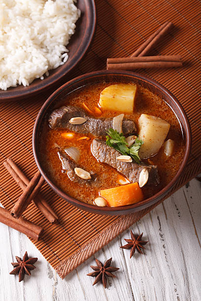 istock traditional Thai beef massaman curry close-up. vertical top vie 501799478