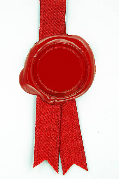 istock Round red wax seal on a red ribbon 501799714