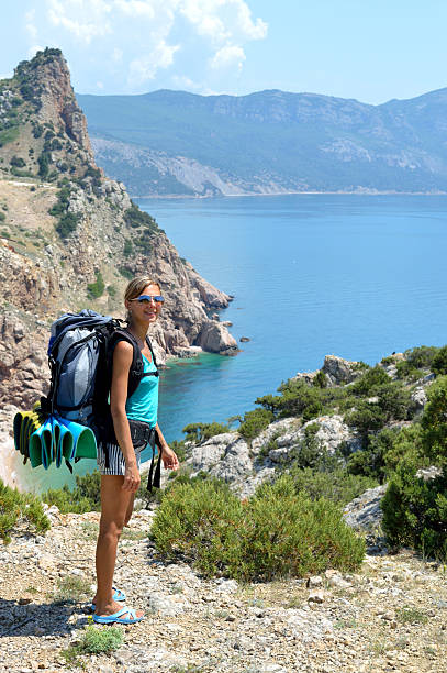 Beautiful tourist girl in mountains nearly sea stock photo