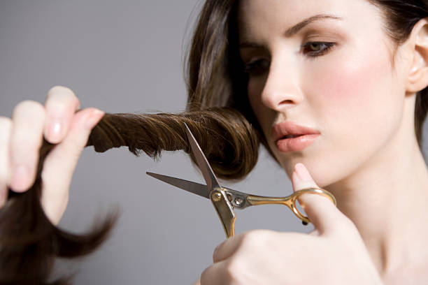 istock Woman Cutting Long Brown Hair 501814327