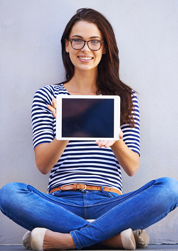 Shot of an attractive young woman holding up a digital tablet with a blank screenhttp://195.154.178.81/DATA/i_collage/pi/shoots/783649.jpg