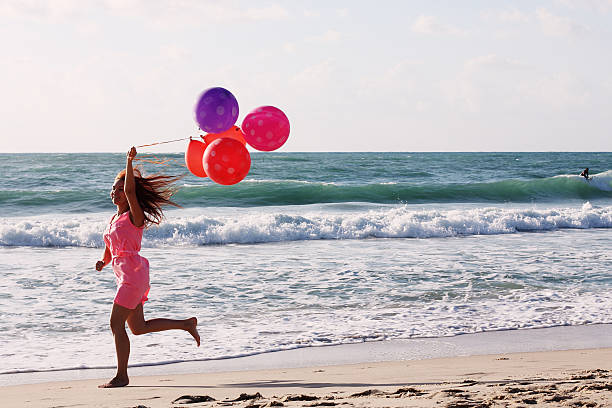 istock woman holding balloons 501814453