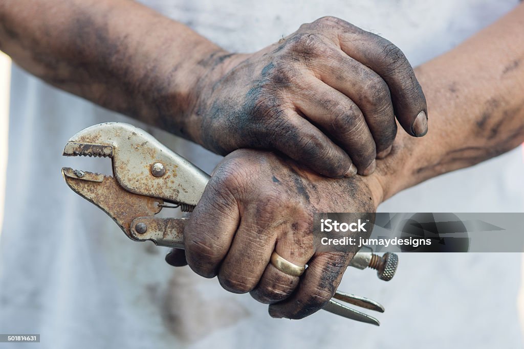 Working Man’s Greasy hands, DIY A man fixes his own car. Resting. Dirty Stock Photo