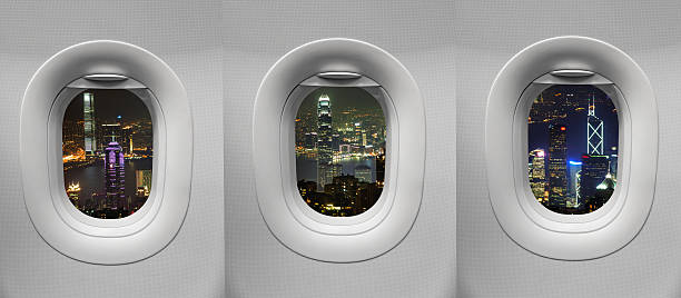 istock night time hong kong at Airplane window 501815363