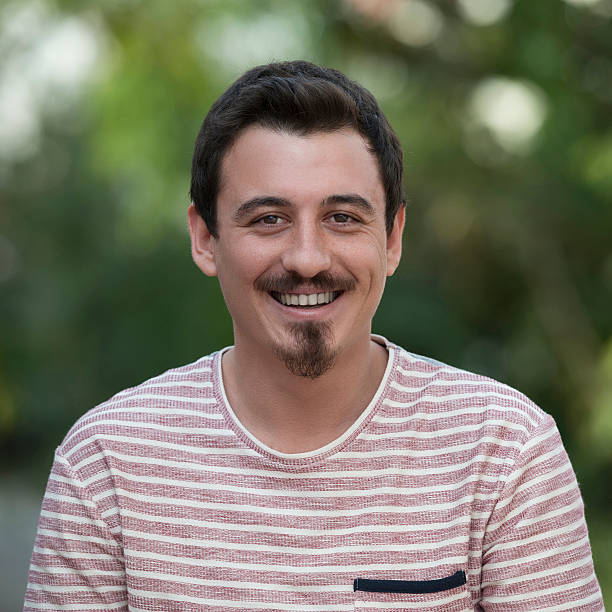 istock Portrait of young man smiling to camera 501815416