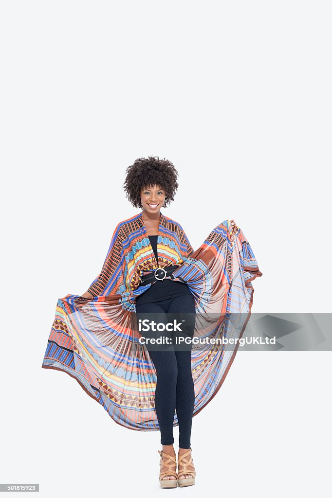 portrait of an African American woman Full length portrait of an attractive African American in traditional wear standing over gray background African Culture Stock Photo