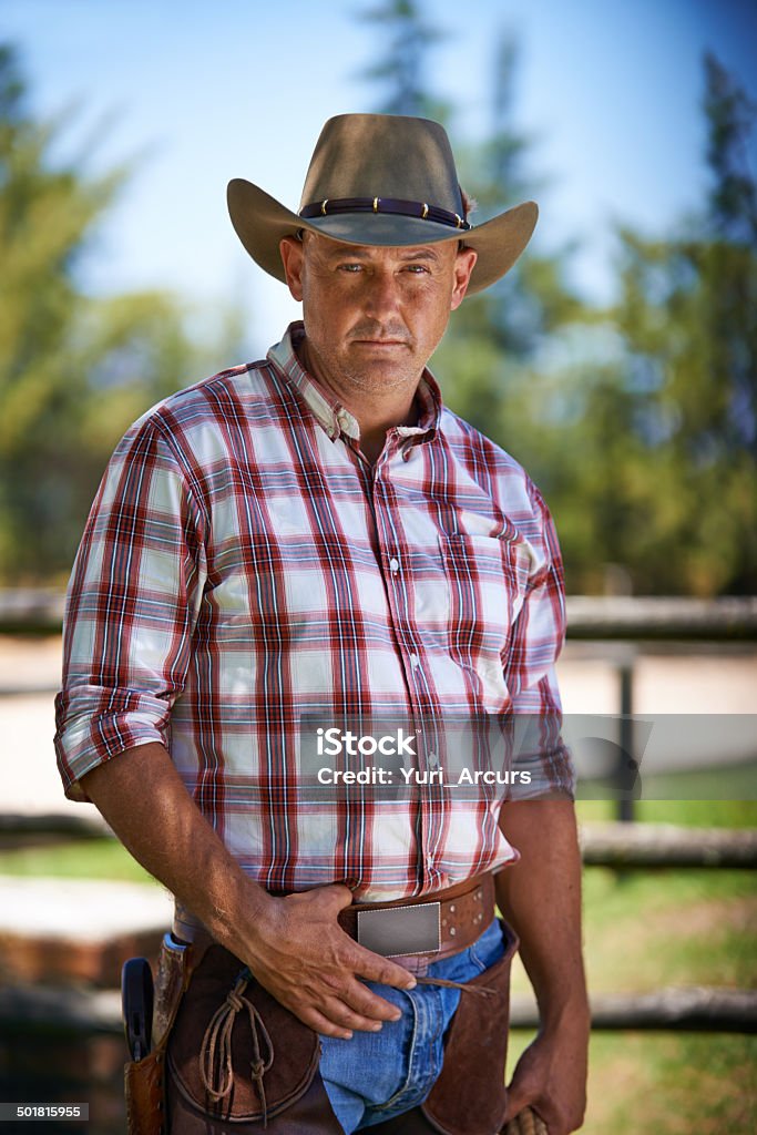 He's got his eye on you A mature cowboy outdoors on his farmhttp://195.154.178.81/DATA/i_collage/pi/shoots/783508.jpg 30-39 Years Stock Photo