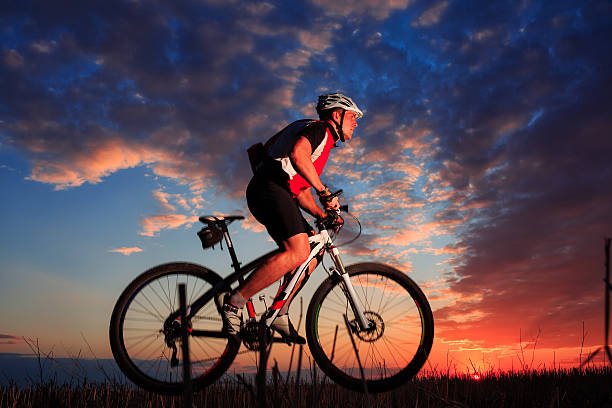 istock Man with bicycle at the sunset outdoor 501816658