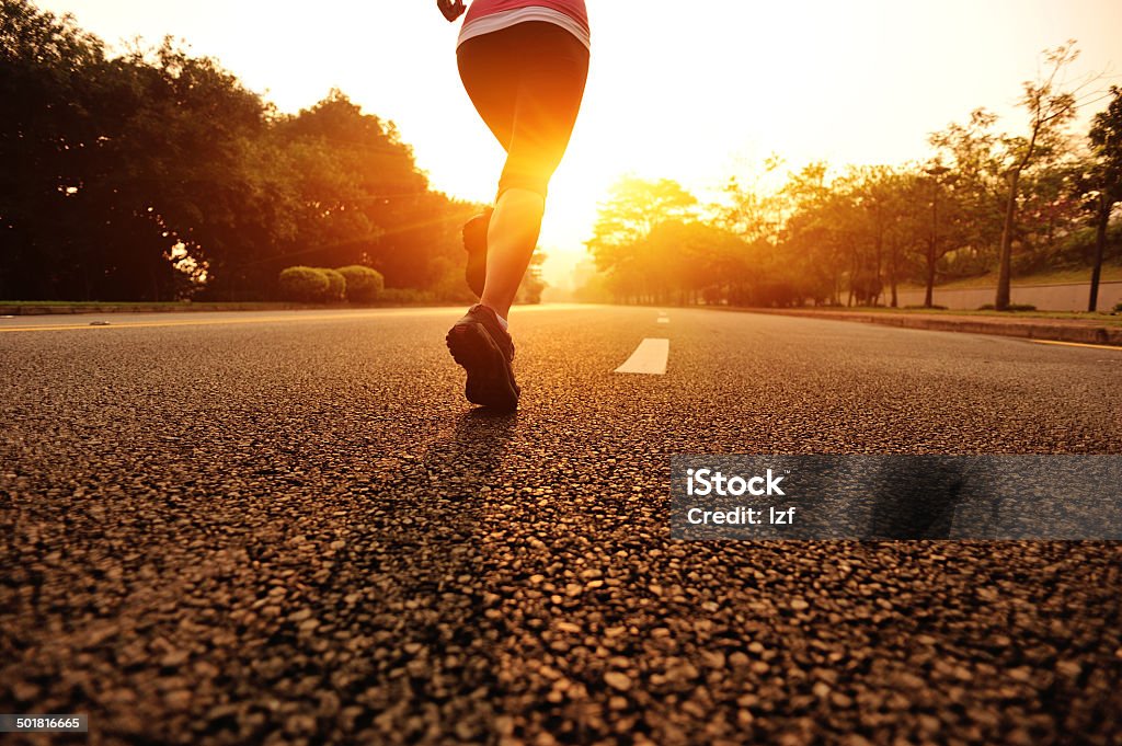 healthy lifestyle fitness sports woman running on road Runner athlete running on road. woman fitness jogging sunrise workout wellness concept. One Woman Only Stock Photo