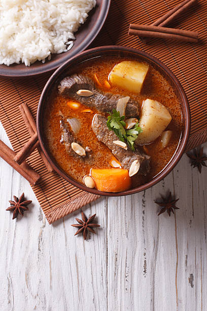 istock Thai beef massaman curry and rice dish. vertical top view 501816694