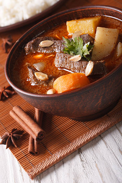 istock Thai beef massaman curry with peanuts close-up in bowl. vertical 501817802