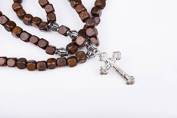 istock Rosary with a cross on a white background 501817856