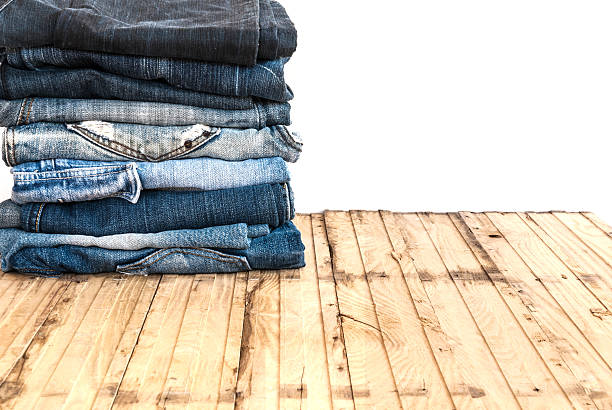 istock Blue jeans trouser roll up isolated on the wood 501818270