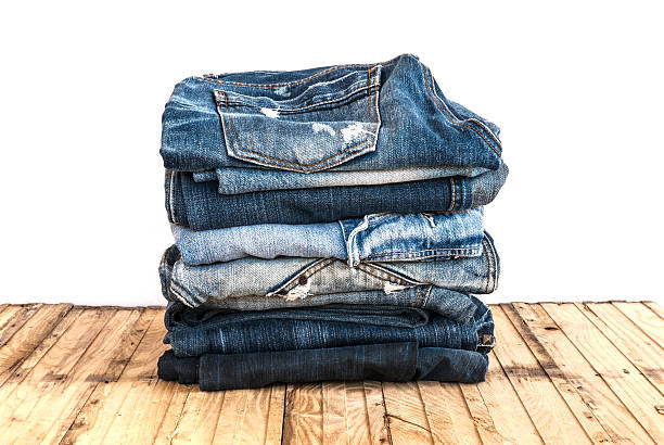 istock Blue jeans trouser roll up isolated on the wood 501818512