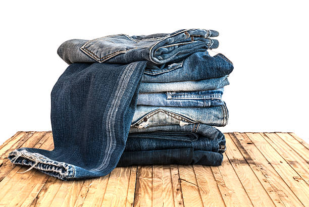 istock Blue jeans trouser roll up isolated on the wood 501818658