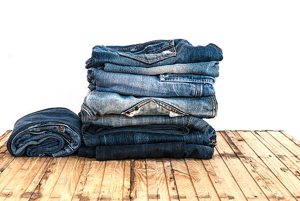istock Blue jeans trouser roll up isolated on the wood 501818788