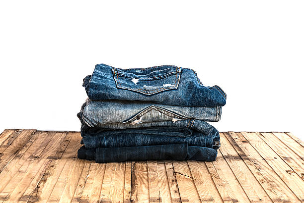 istock Blue jeans trouser roll up isolated on the wood 501819240