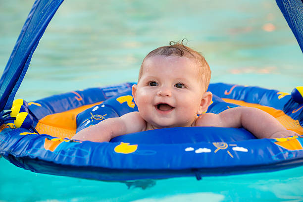 istock Happy infant baby boy enjoying his first swim 501819443
