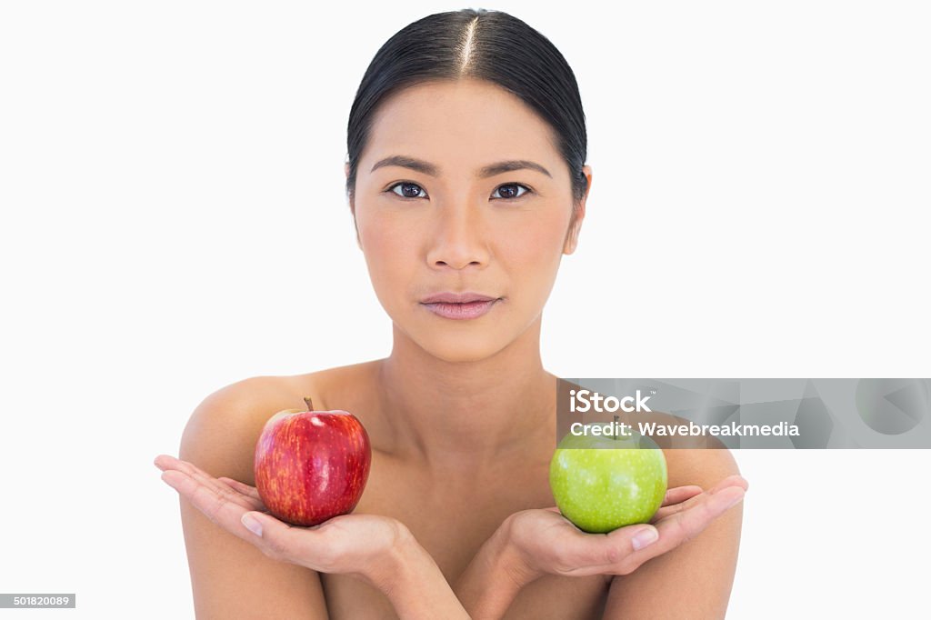 Natural brunette holding apples in both hands Natural brunette holding apples in both hands on white background 20-29 Years Stock Photo
