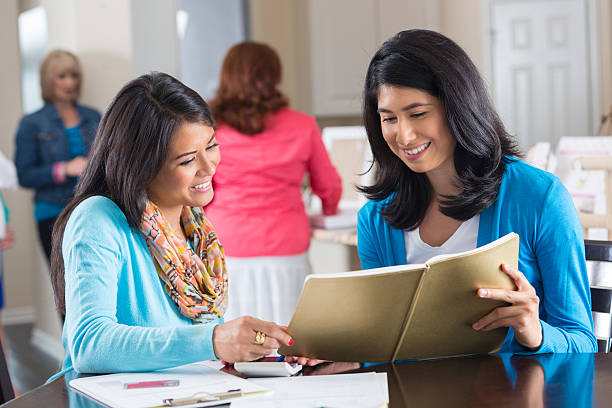 istock Women ordering from catalog at home party sales event 501820105