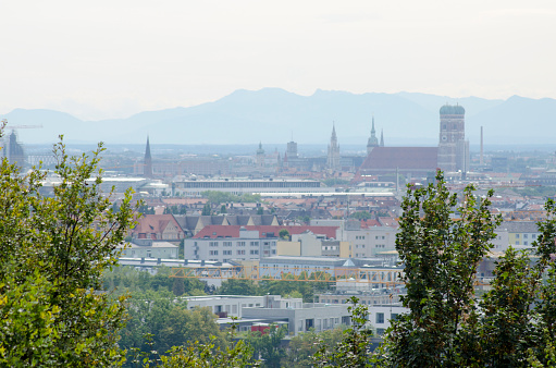 Munich, capital city of Germany's Free State of Bavaria. City skyline, view from olympic park. The Alps visible in the background.