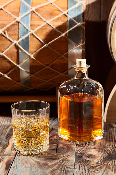 istock Glass of whiskey with ice and a bottle 501824498