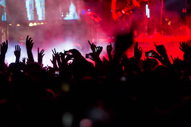 istock People taking photographs with touch smart phone during a music 501824672