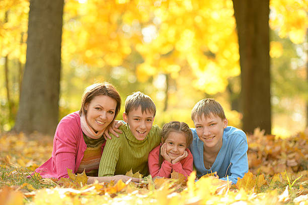 istock Family relaxing in autumn park 501824678