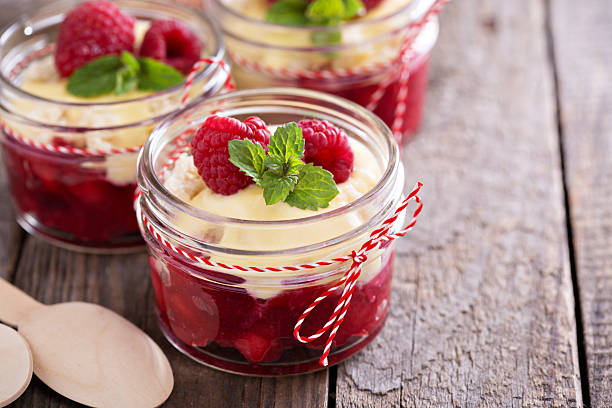 Colorful and delisious dessert in a jar berry cramble Colorful and delisious dessert in a jar berry cramble with vanilla sauce cake jar stock pictures, royalty-free photos & images