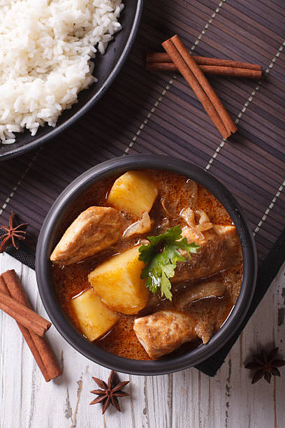 istock Thai massaman curry with chicken and rice close-up. vertical top 501825262