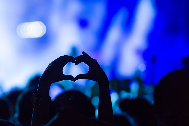 istock People taking photographs with touch smart phone during a music 501825876