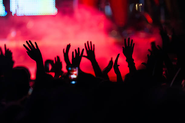 istock People taking photographs with touch smart phone during a music 501826518