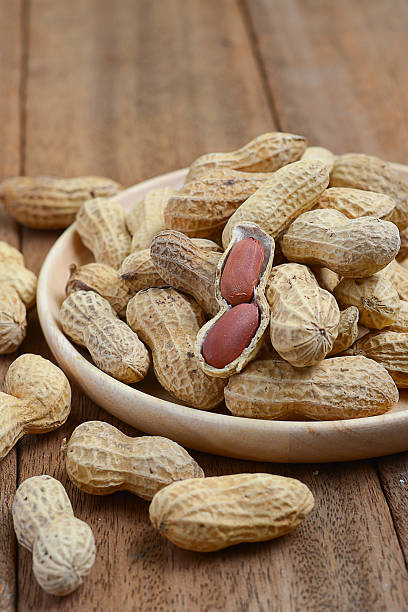 istock Close up of roasted peanuts on wooden table 501827542
