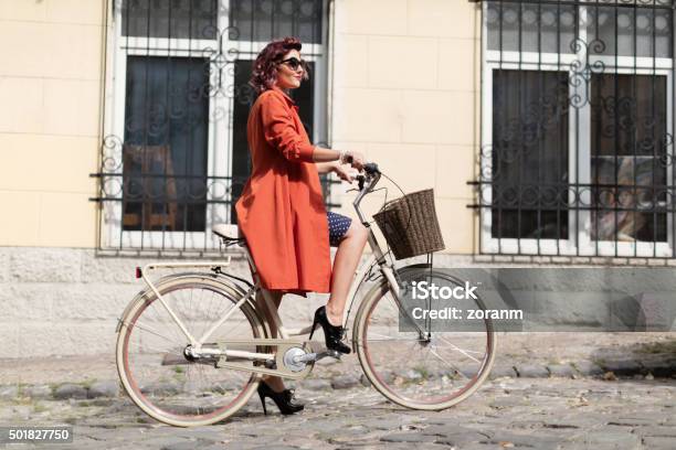 Retro Styled Woman Riding A Bike Stock Photo - Download Image Now - 1940-1949, Women, One Woman Only