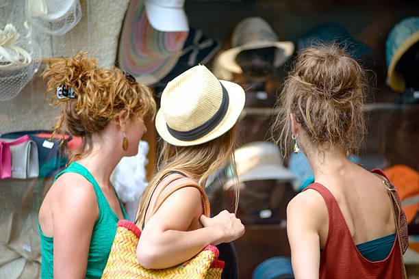 three young women are shopping in the city