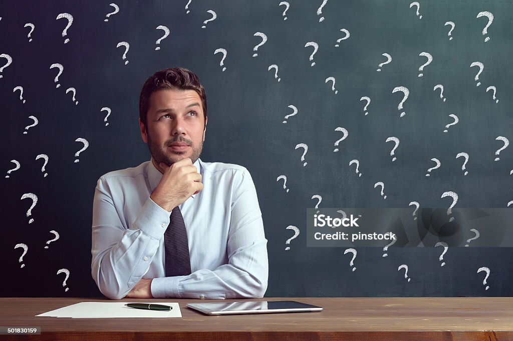 Businessman Caucasian casual businessman is working on his desk. Question Mark Stock Photo
