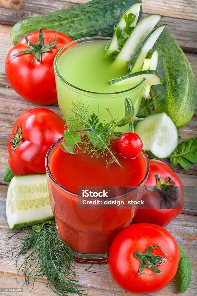 tomato and cucumber juices Healthy domestic tomato and cucumber  juices on a wooden table Antioxidant Stock Photo