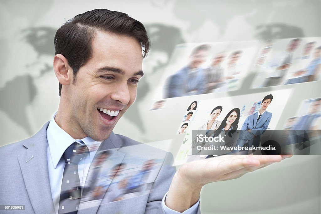 Content businessman looking at pictures Content businessman looking at pictures on digital screen on map background 20-29 Years Stock Photo