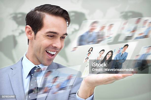 Content Businessman Looking At Pictures Stock Photo - Download Image Now - 20-29 Years, Adult, Adults Only