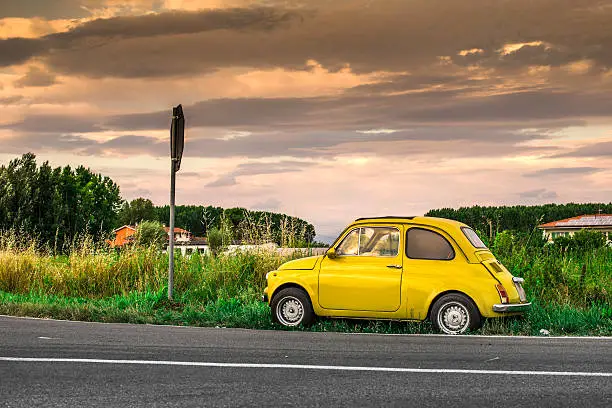 Small vintage italian car Fiat Abarth. Yellow color
