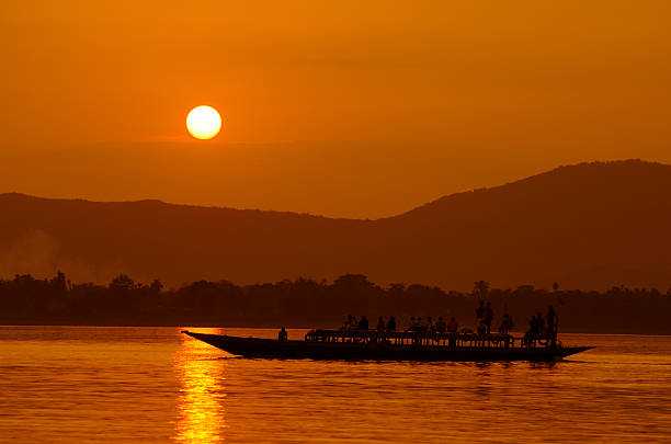 Brahmaputra_at_Sunset Brahmaputra river is lifeline of Assam, India. People use it for transportation, fishery etc. and therefore it is worshiped. It is surrounded by full of natural beauty. brahmaputra river stock pictures, royalty-free photos & images