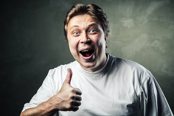 istock Happy man giving thumbs up sign on gray 501836955