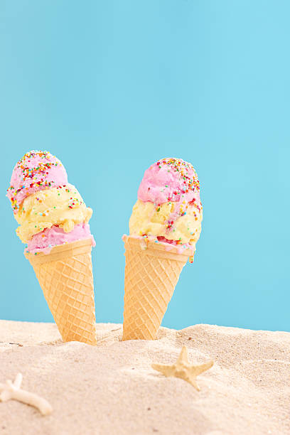 istock Vertical shot of two ice creams stuck in sand 501837433
