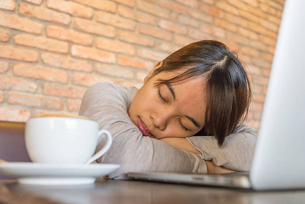 istock Young girl is too tired and sleep although drinking coffee 501843358