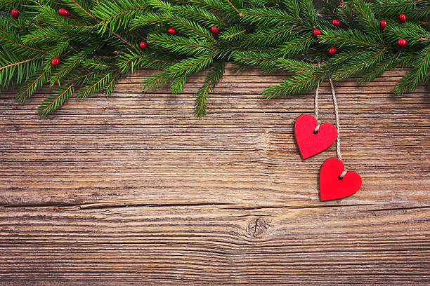 istock Christmas tree with red hearts,  wooden  background, copy space. Toned 501846170
