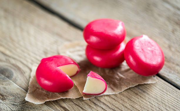 Stack of mini cheese on the wooden table Stack of mini cheese on the wooden table Babybel Cheese stock pictures, royalty-free photos & images