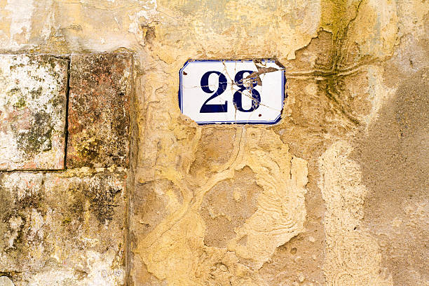 istock Number 28 Street Address Tile On Mottled Old Yellow Wall 501847460