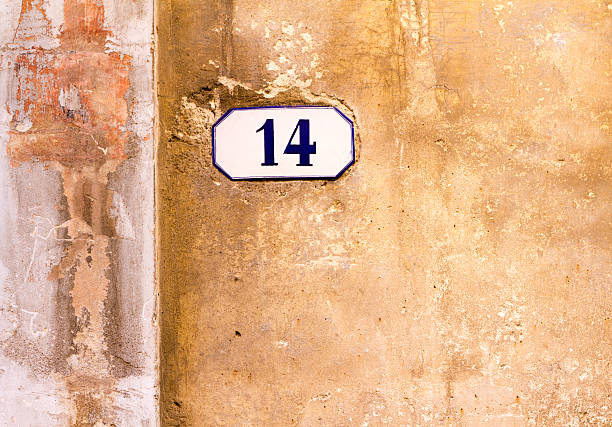 istock Number 14 Street Address Tile On Old Yellow-Orange Wall 501847674